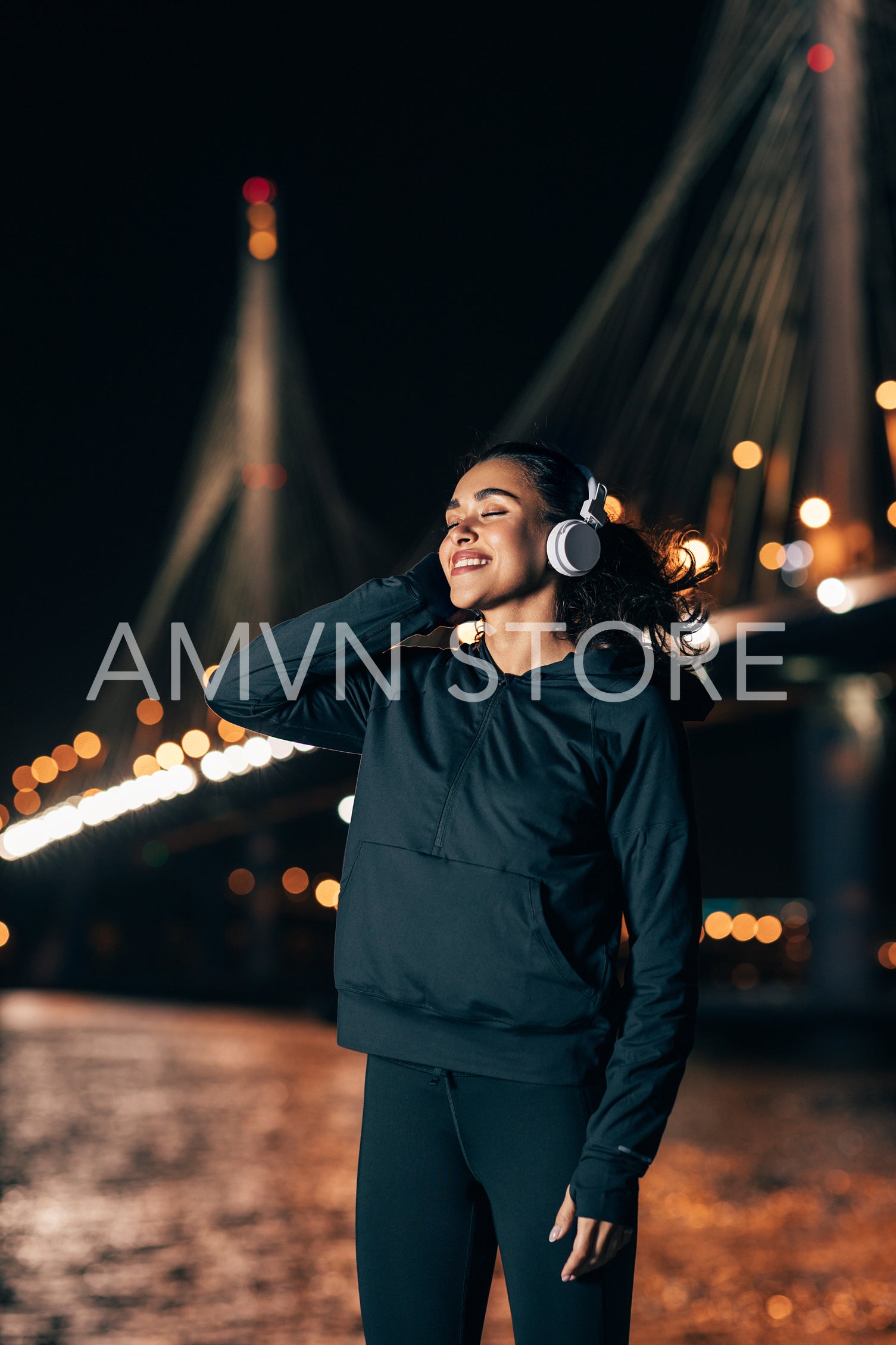 Smiling sportswoman relaxing during fitness training at night