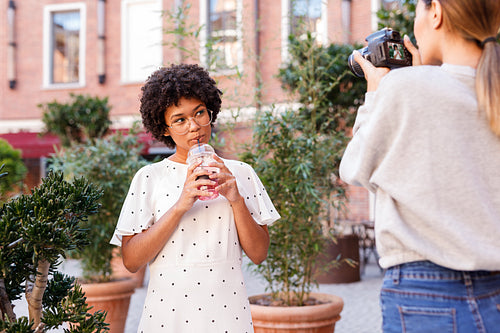 Photographer collaborating with a blogger. Two women creating content for social media.