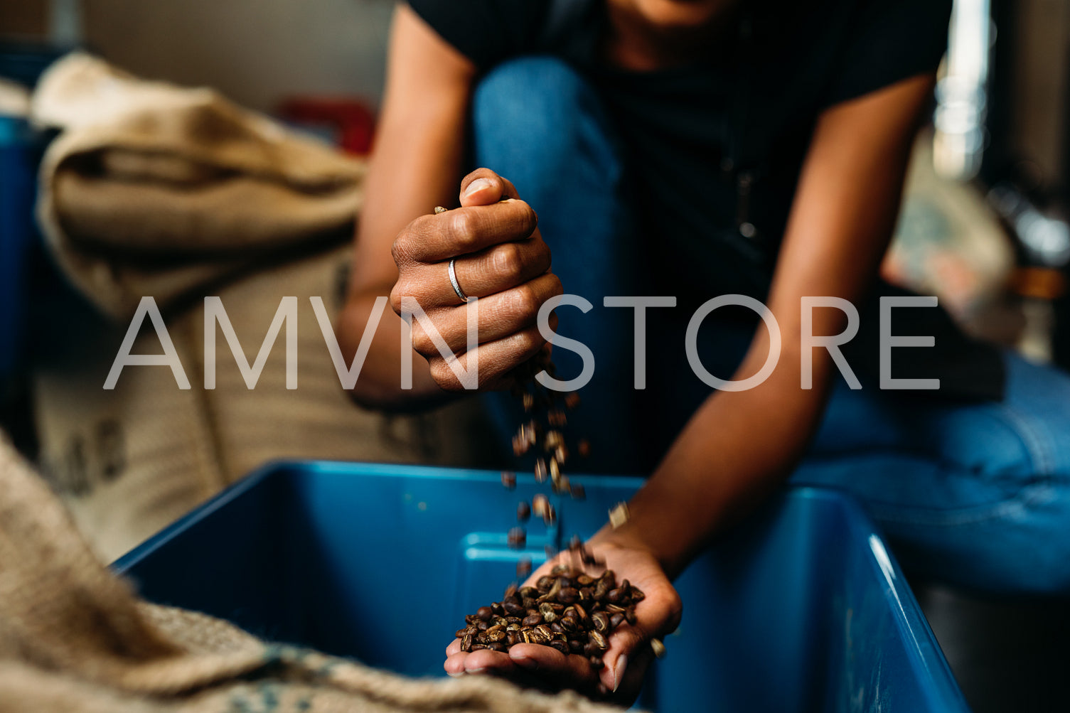 Unrecognizable woman with coffee beans in her hands	