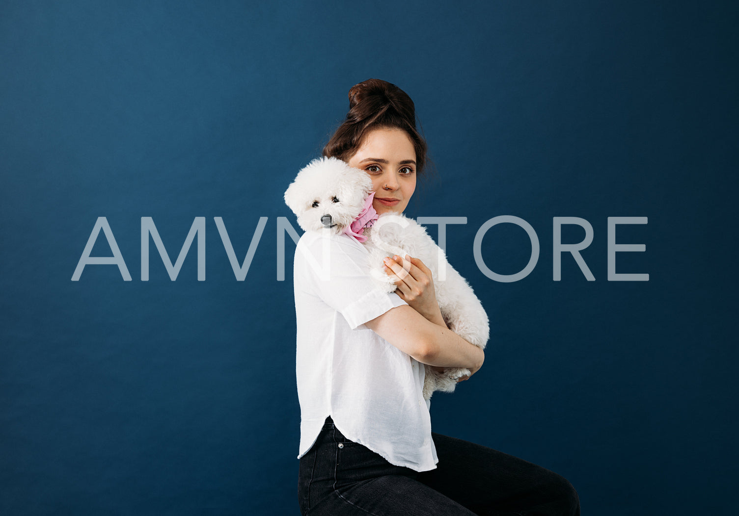 Portrait of a young woman with her white fluffy dog