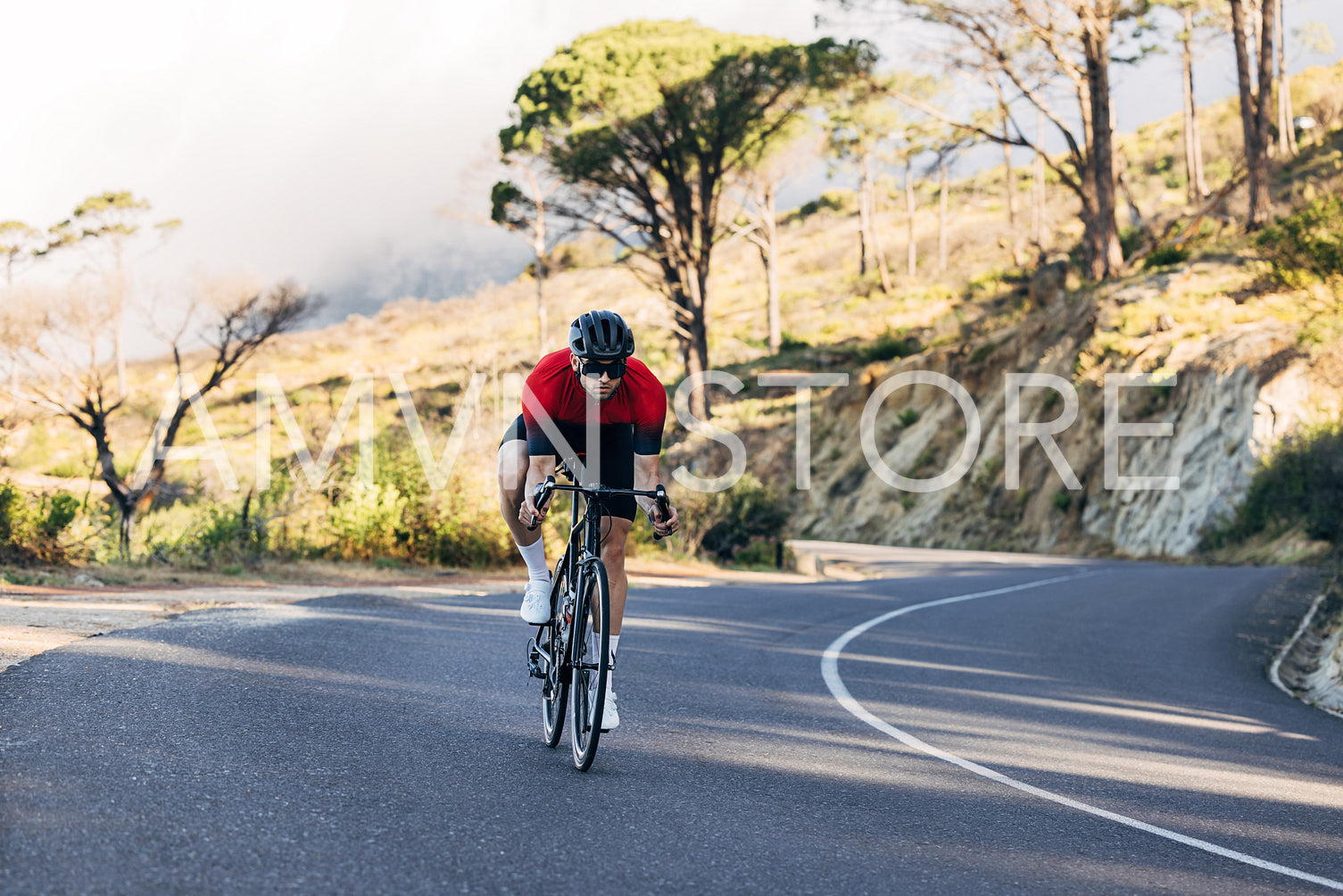 Male cyclist doing a ride on a road bike. Man in sports clothes on a bicycle.