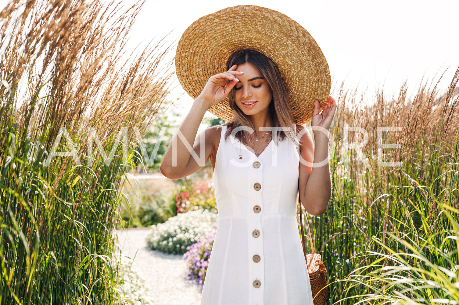 Stylish female tourist walking through the grass in the countryside	