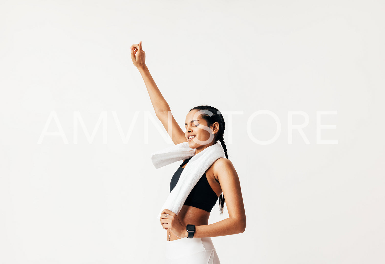 Female athlete with closed eyes jumping against white background raising a hand up