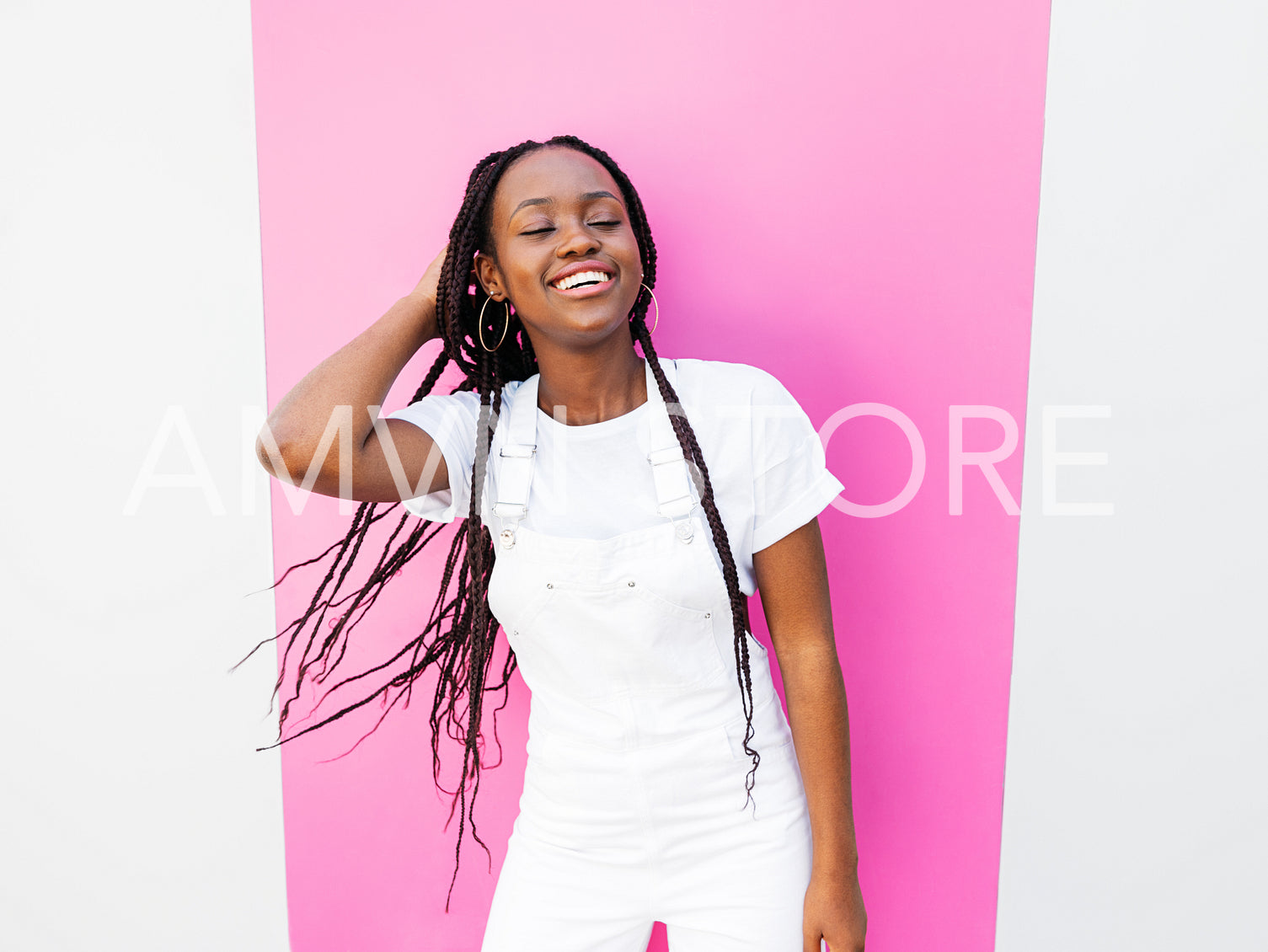 Portrait of a happy beautiful woman with braids wearing white casual clothes 