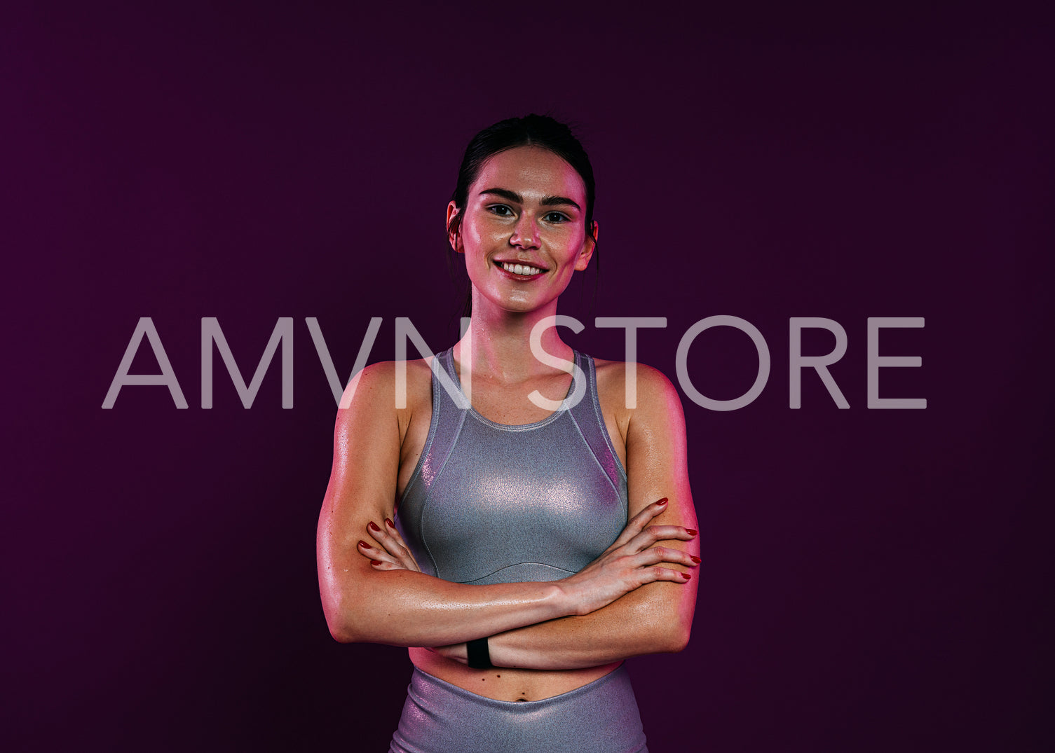 Portrait of a smiling confident sportswoman in silver fitness wear