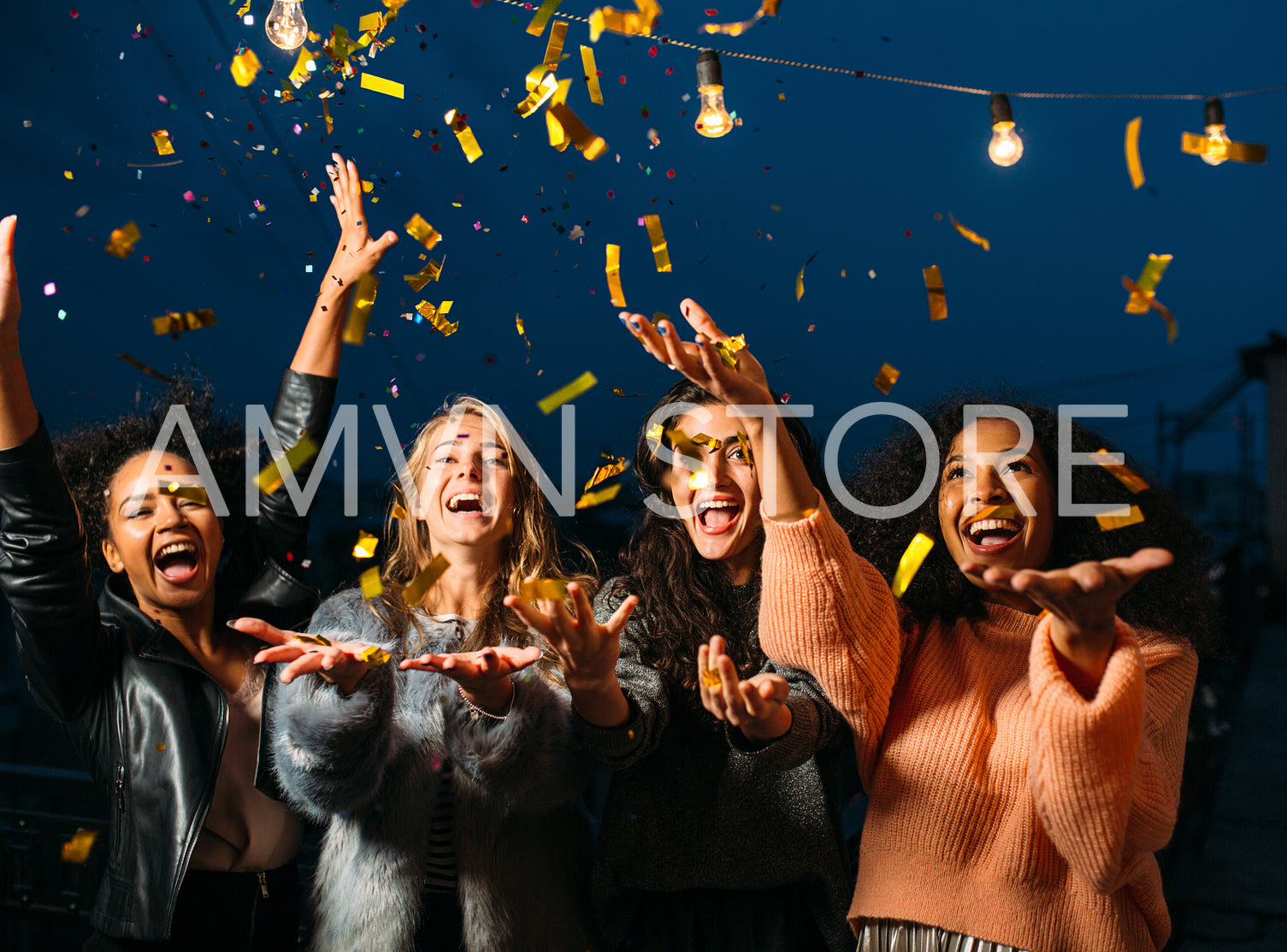 Outdoor shot of group friends laughing under confetti	