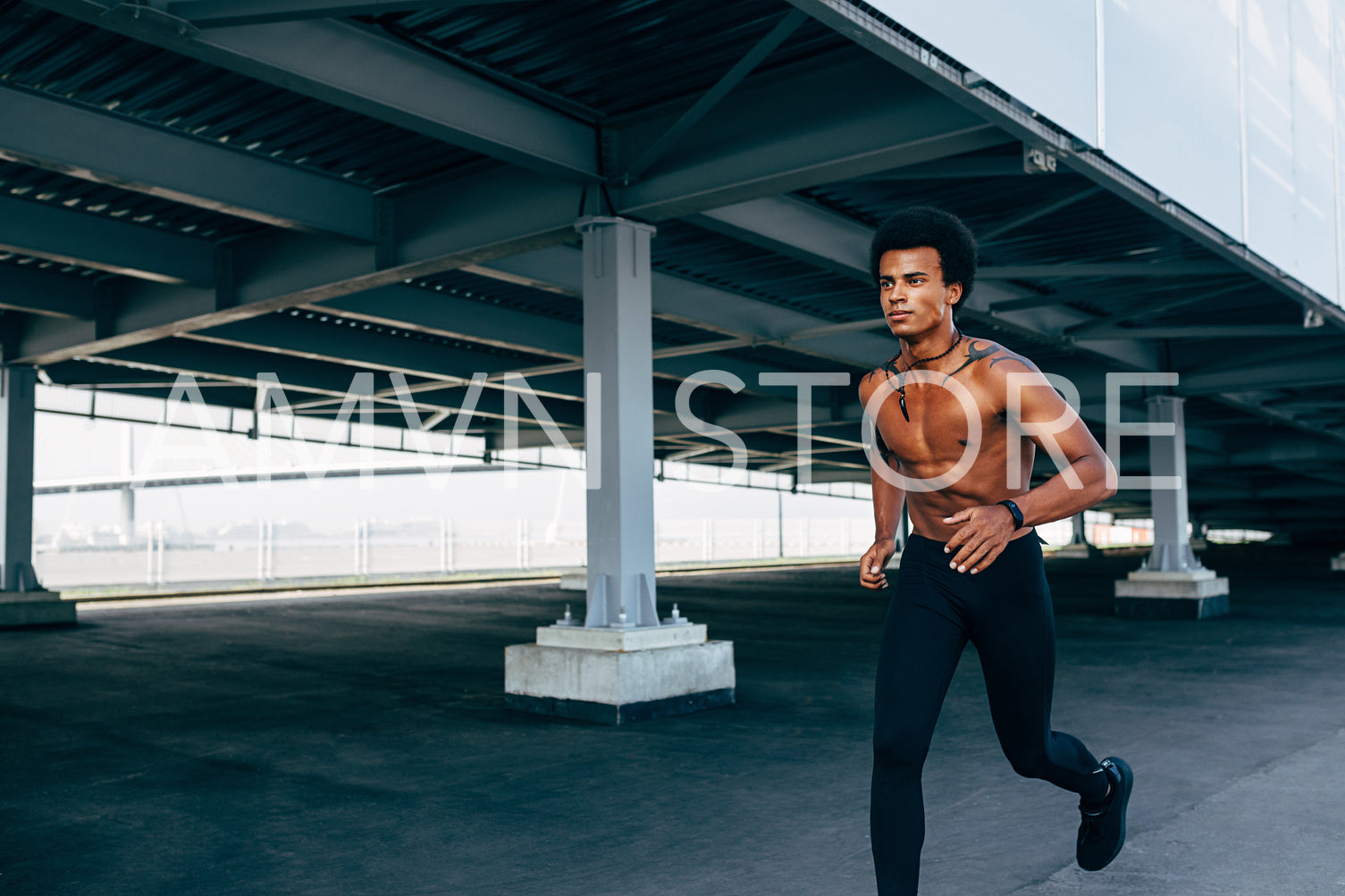 Bare chested sportsman running at bridge outdoors	