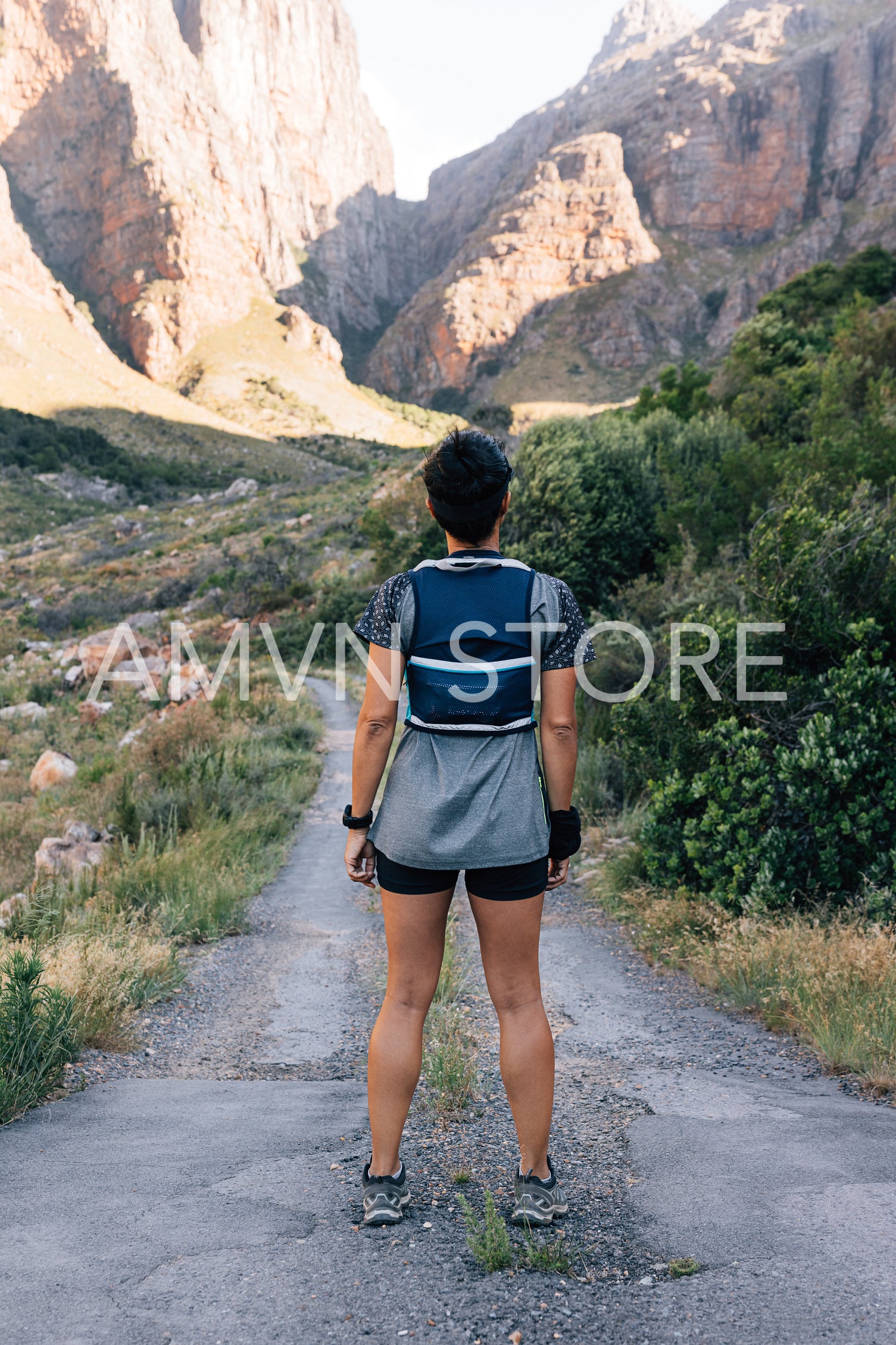 Young healthy hiker standing on abandoned road