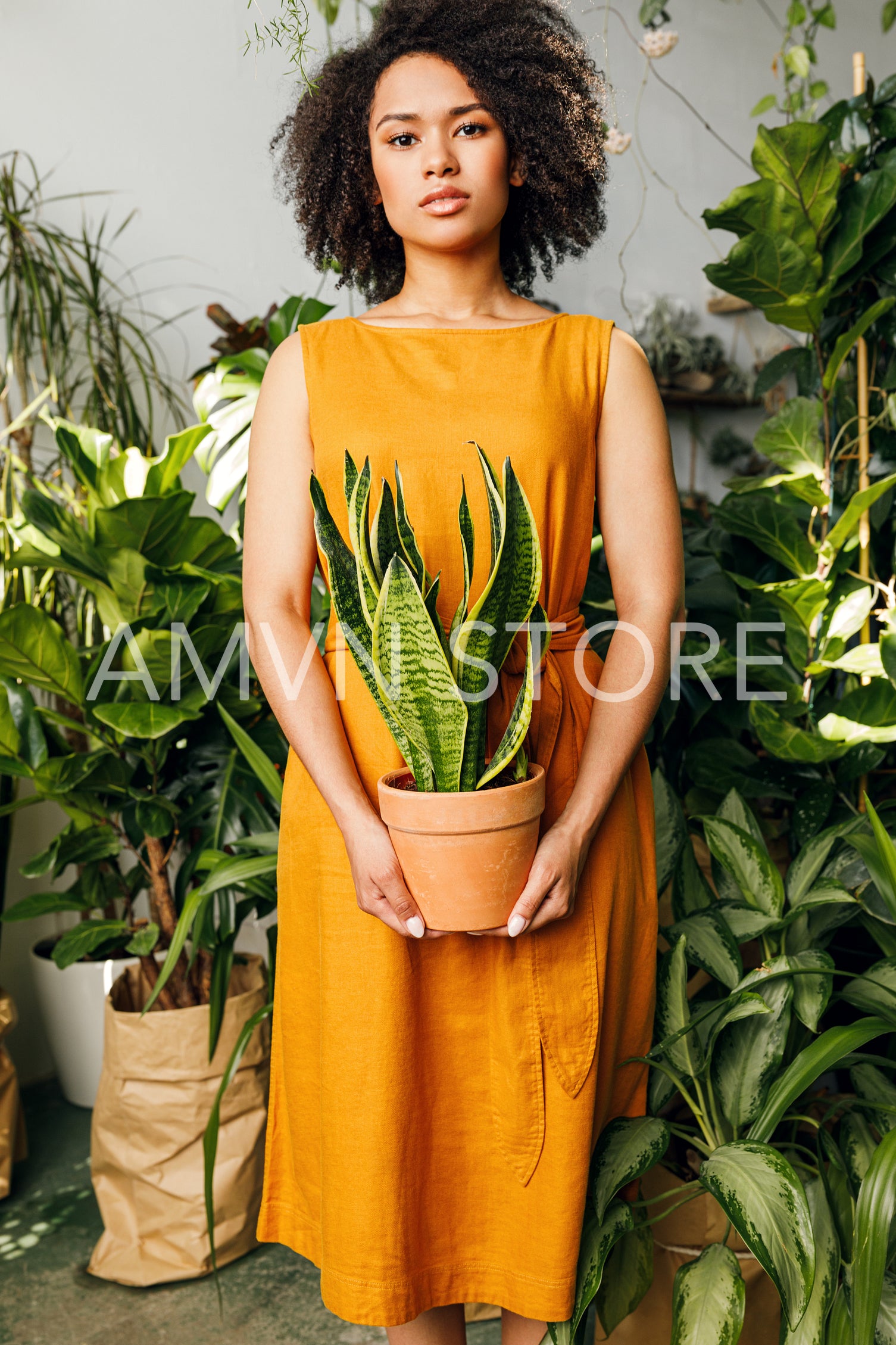 Beautiful woman florist holding a plant