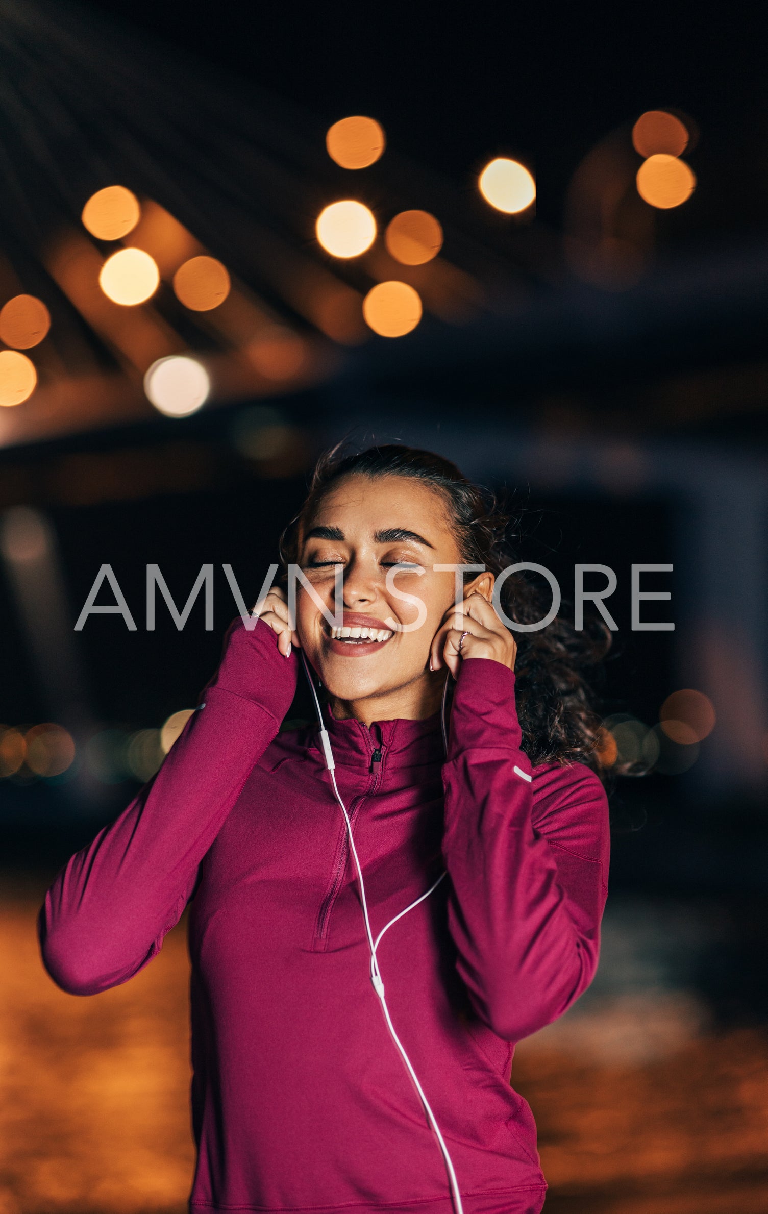 Female runner listening to music on earphones at night