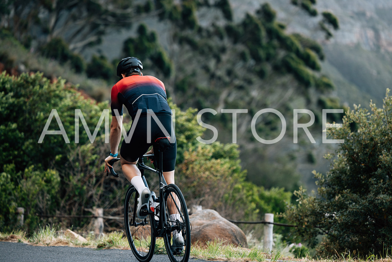 Back view on a cyclist riding a bicycle in wild terrain