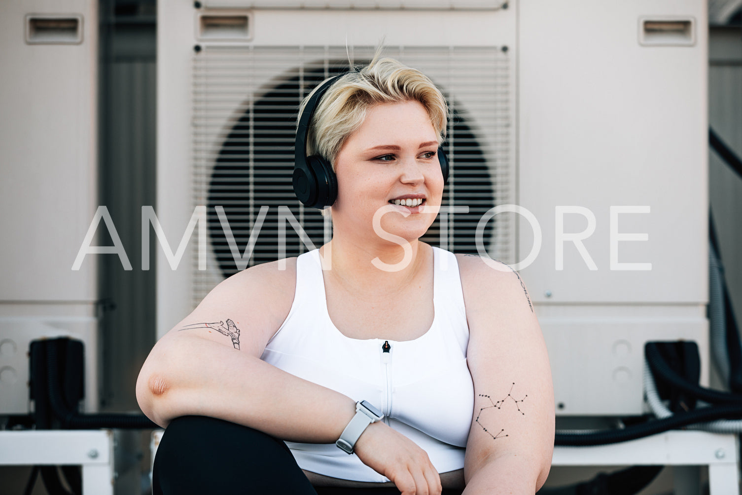 Portrait of a plus size woman in sportswear taking a break during a workout on a roof