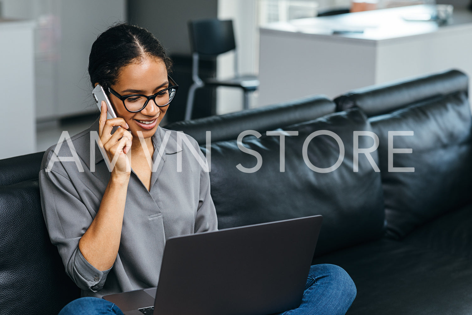 Beautiful woman using a smartphone having phone call from her apartment. Businesswoman enjoying conversation sitting on a couch.	