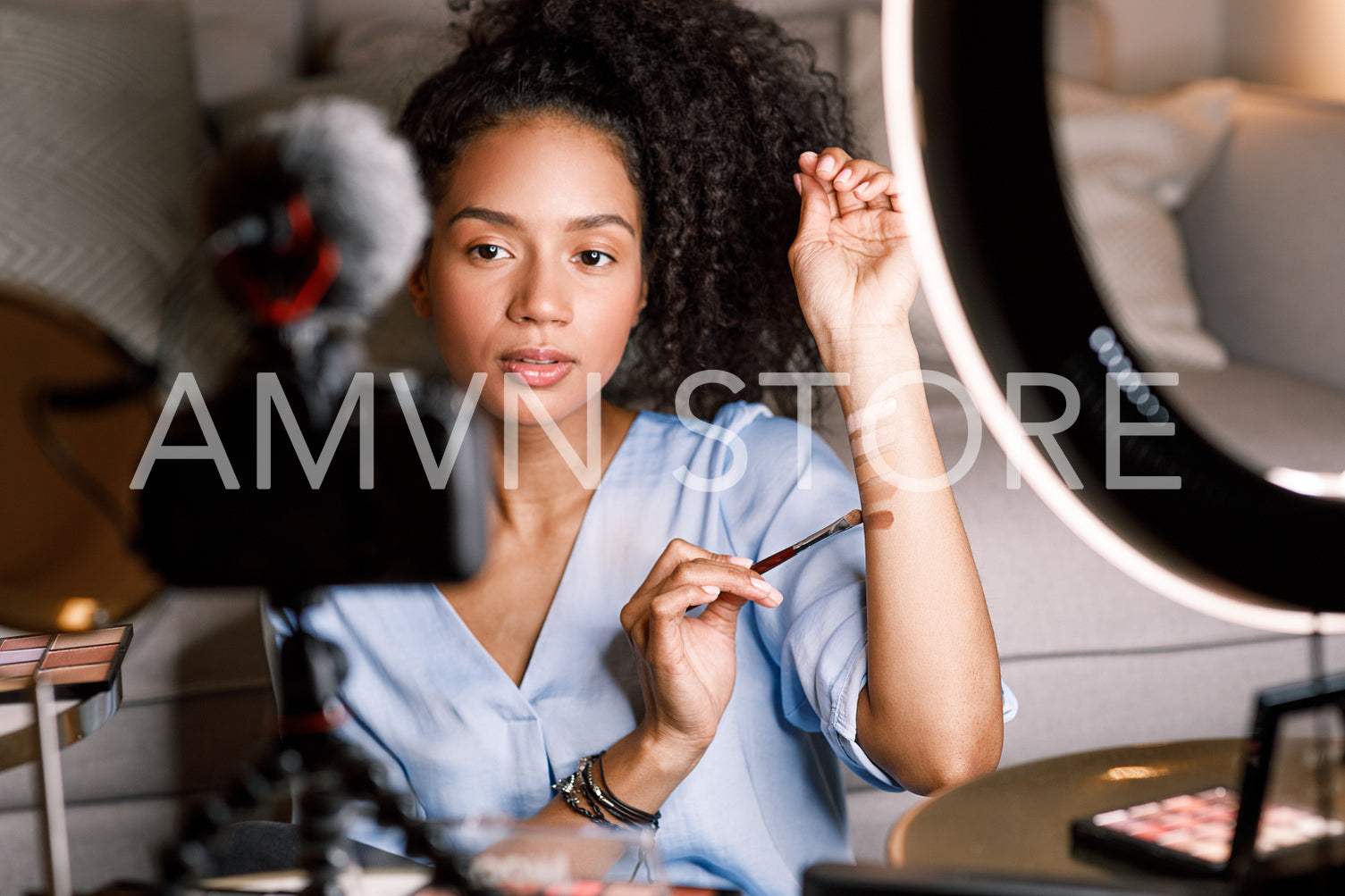 Young influencer showing the pallete of tonal cream on her hand