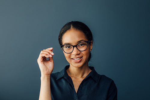 Close up portrait of a young businesswoman wearing spectacles and looking at camera