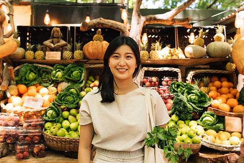 Portrait of a young Asian woman while standing at an outdoor market