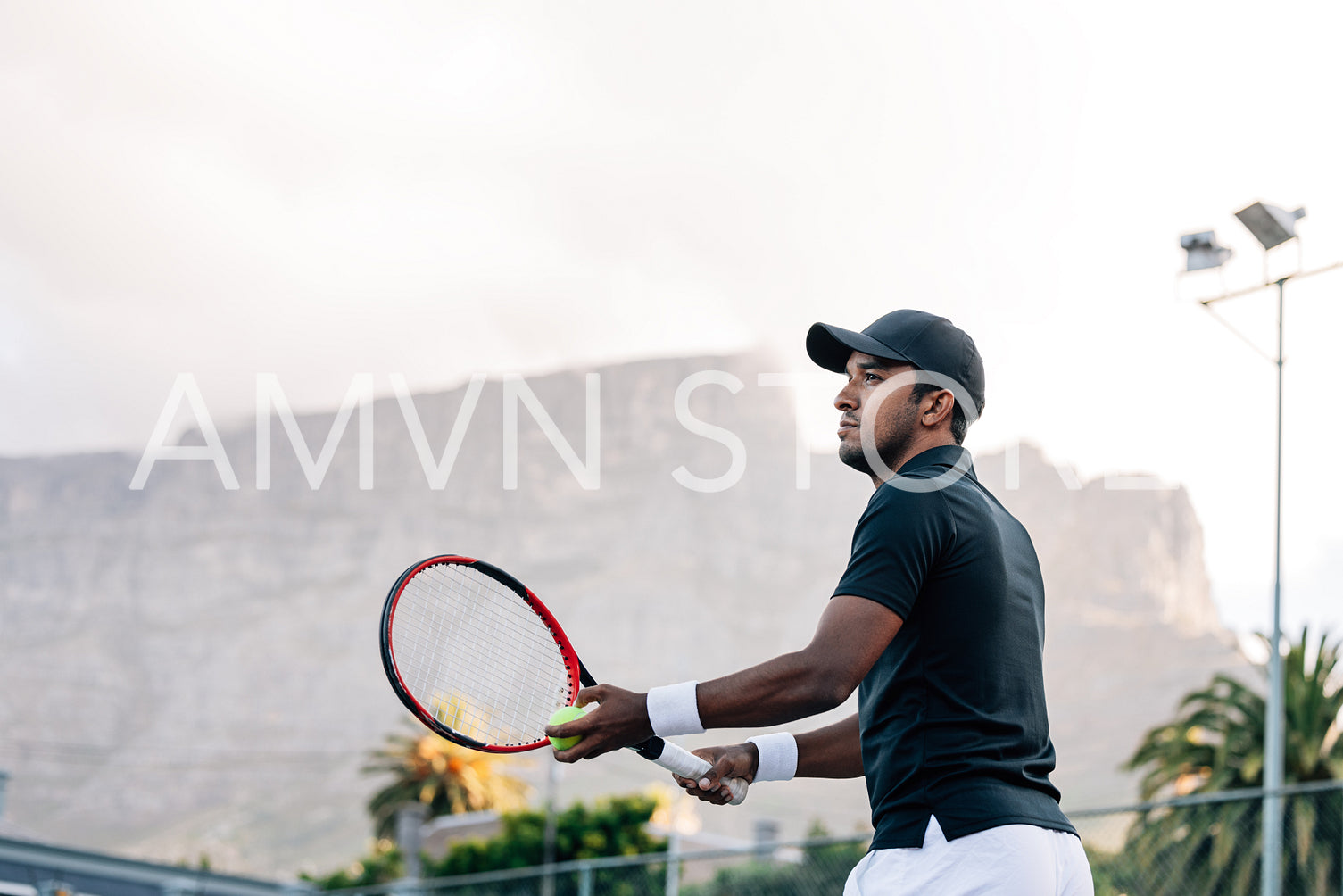 Tennis player preparing to serve a tennis ball 