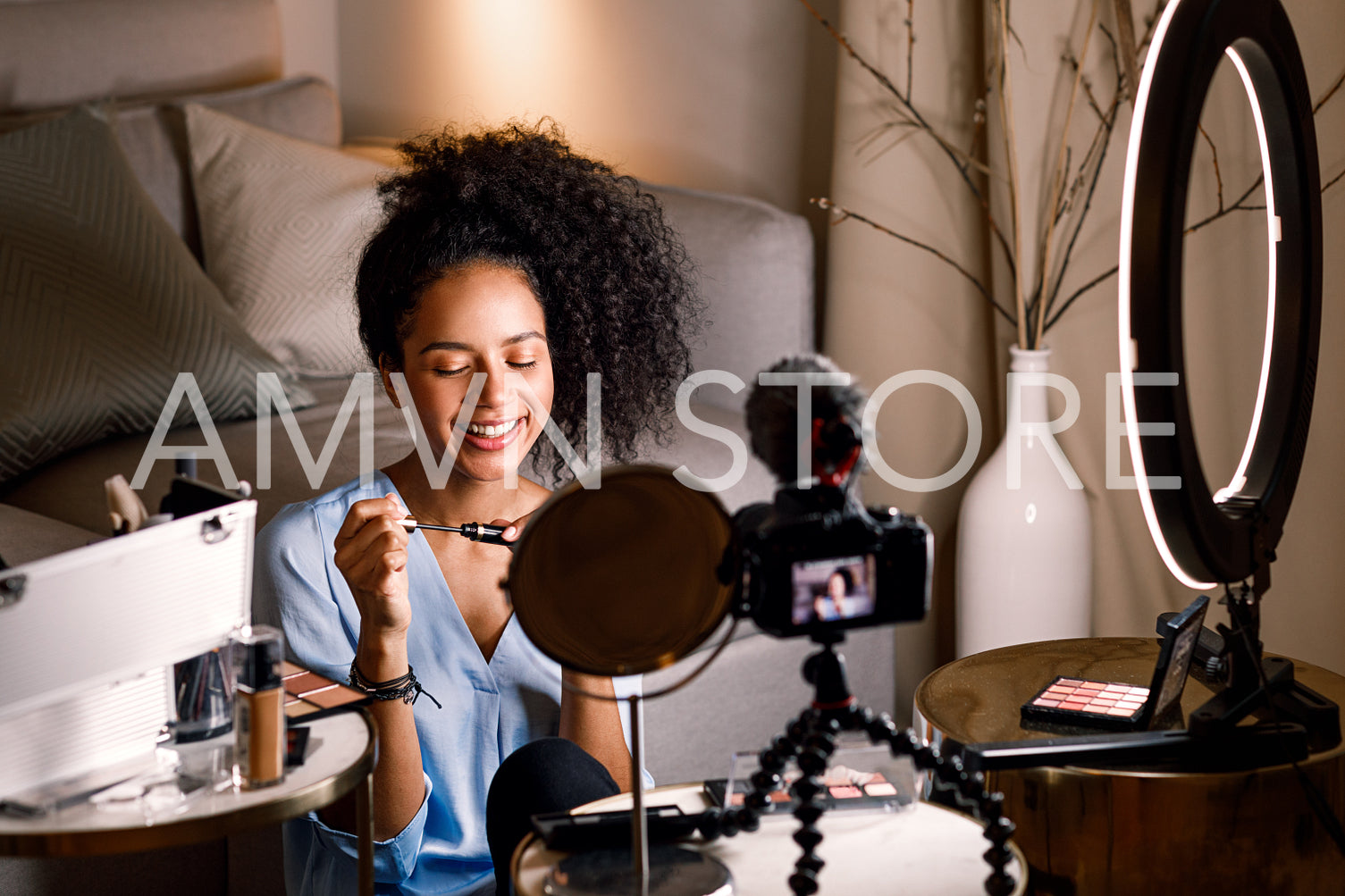 Smiling beauty vlogger holding a mascara. Woman recording video content.	