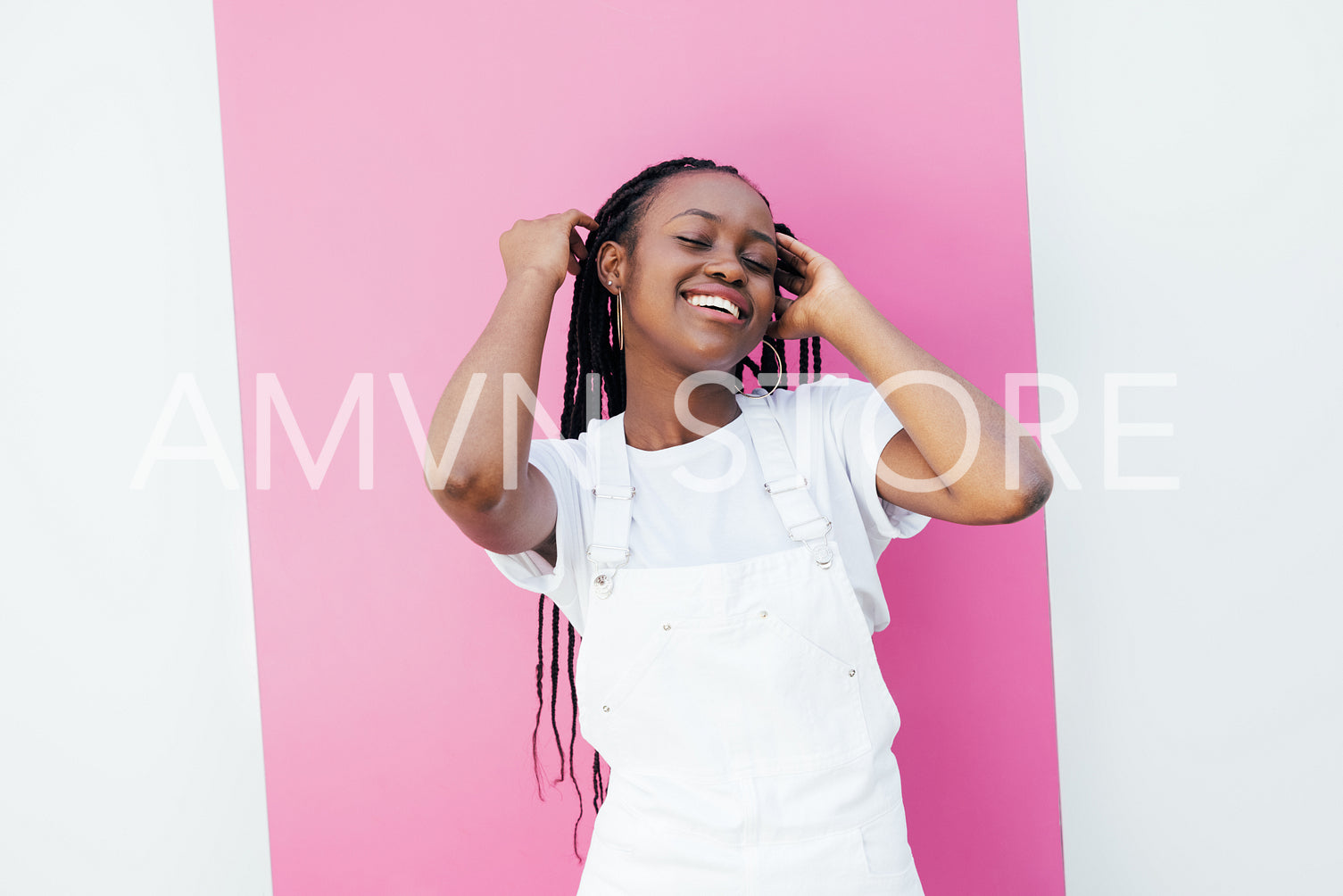 Young cheerful girl in white casuals standing against pink stripe outdoors