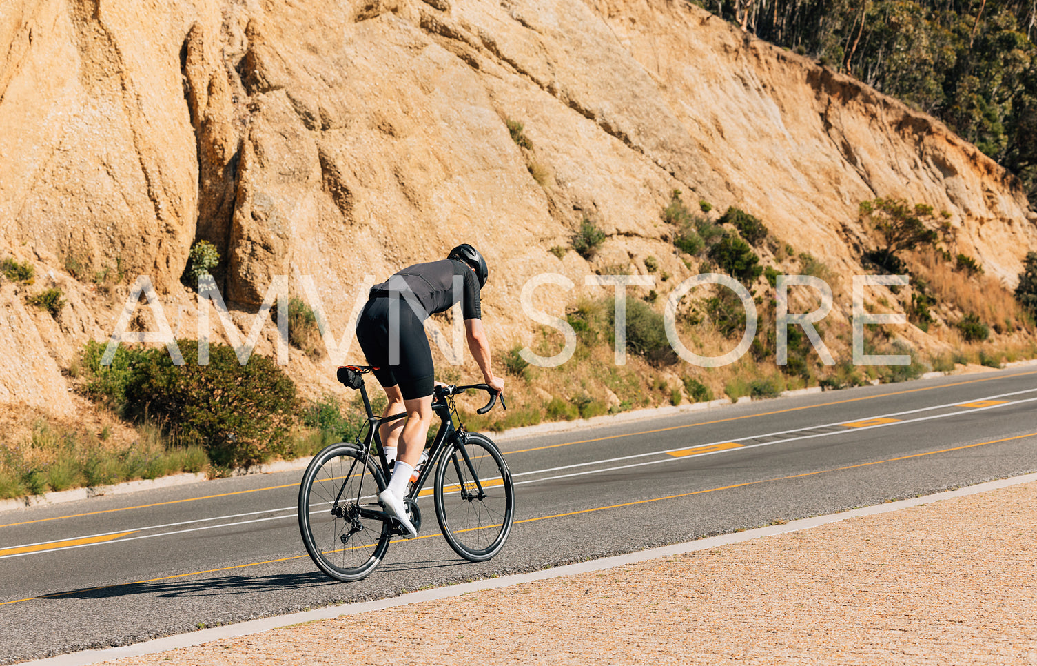 Male cyclist riding on an empty road. Professional cyclist exercising on a road bike.