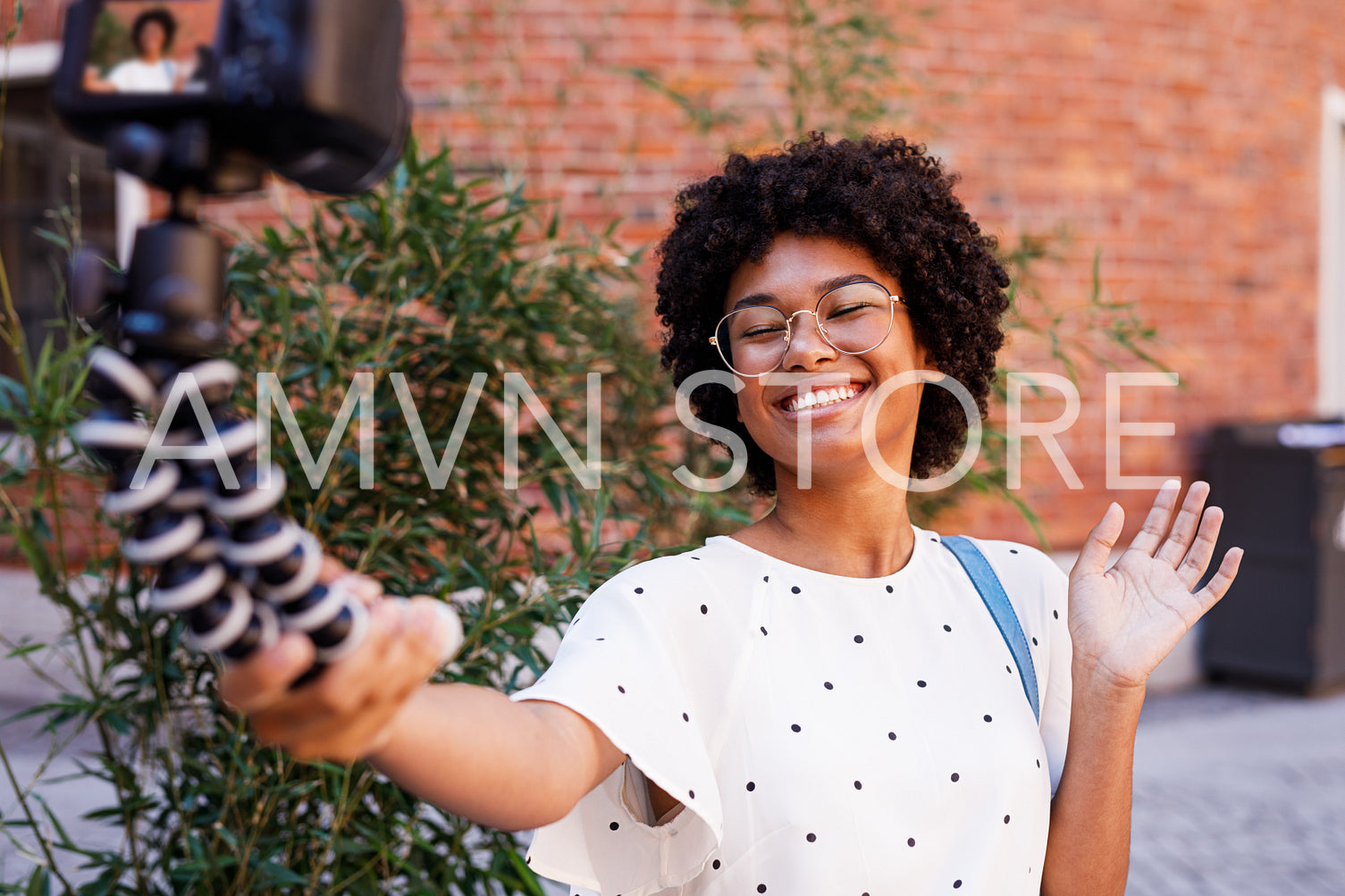 Happy woman recording video on dslr camera	