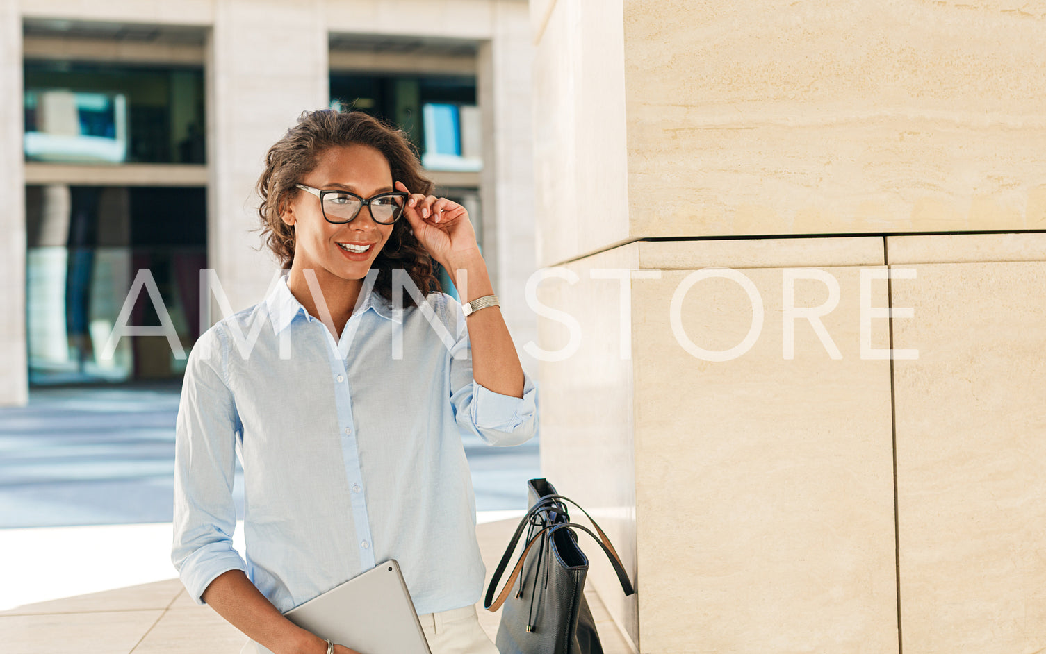 Smiling woman wearing eyeglasses holding digital tablet	