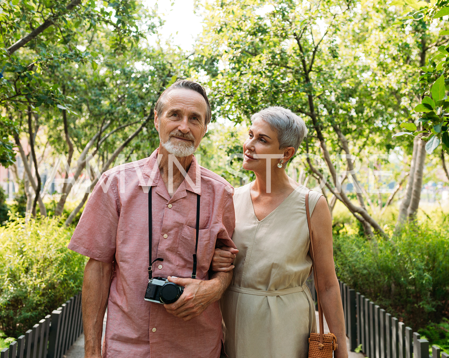 Aged woman and her husband walking in the park