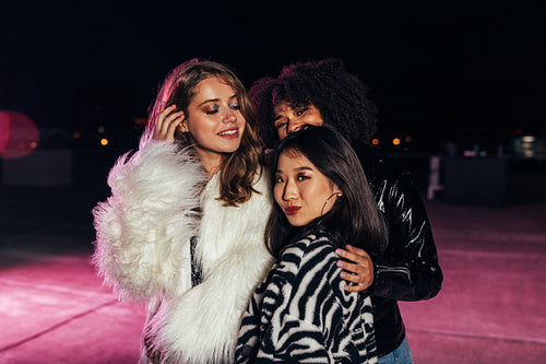 Multiethnic group of stylish girls standing together on roof