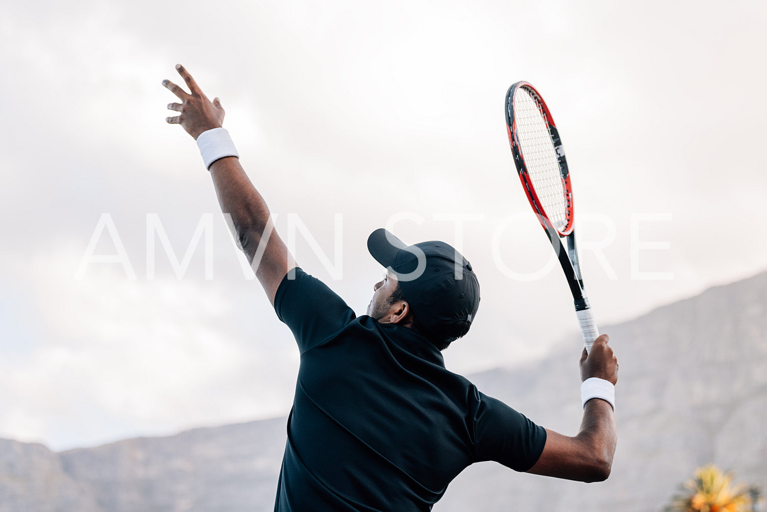 Tennis player hitting a serve. Young tennis player about to hit the ball.