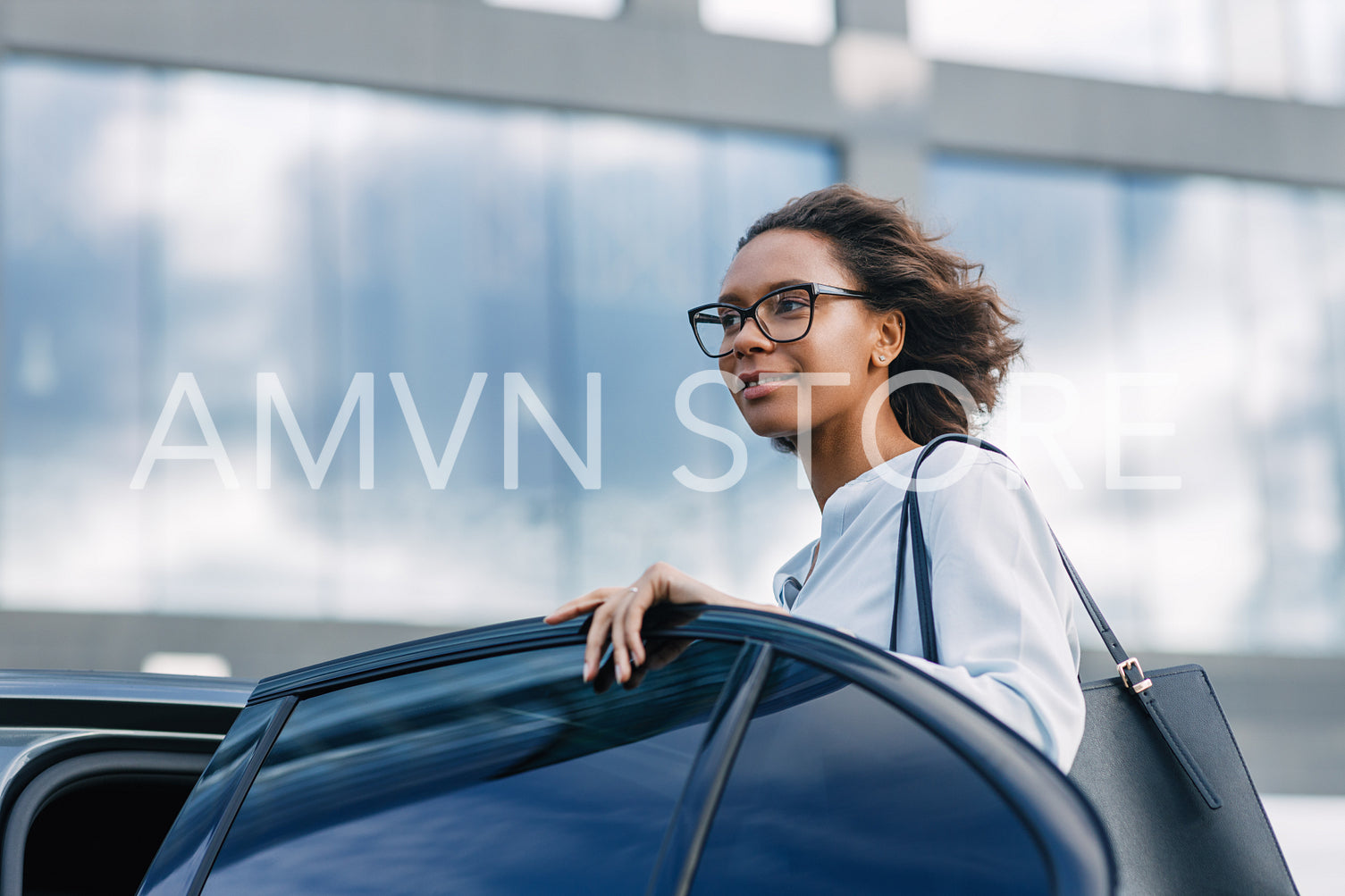 Young businesswoman getting into a taxi. Beautiful female standing at car outdoors.	