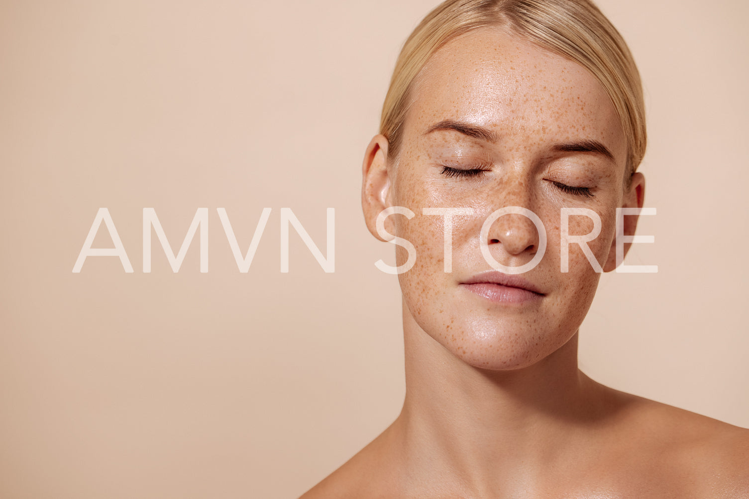 Portrait of a beautiful woman with perfect skin standing with closed eyes in studio against pastel background