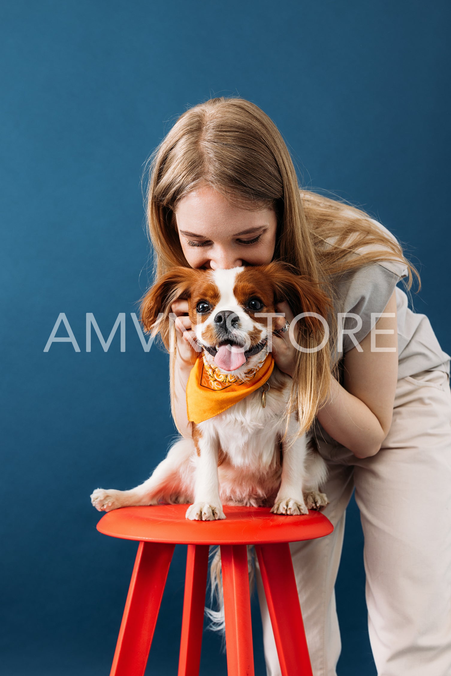 Close up portrait of a young woman and her little dog in studio