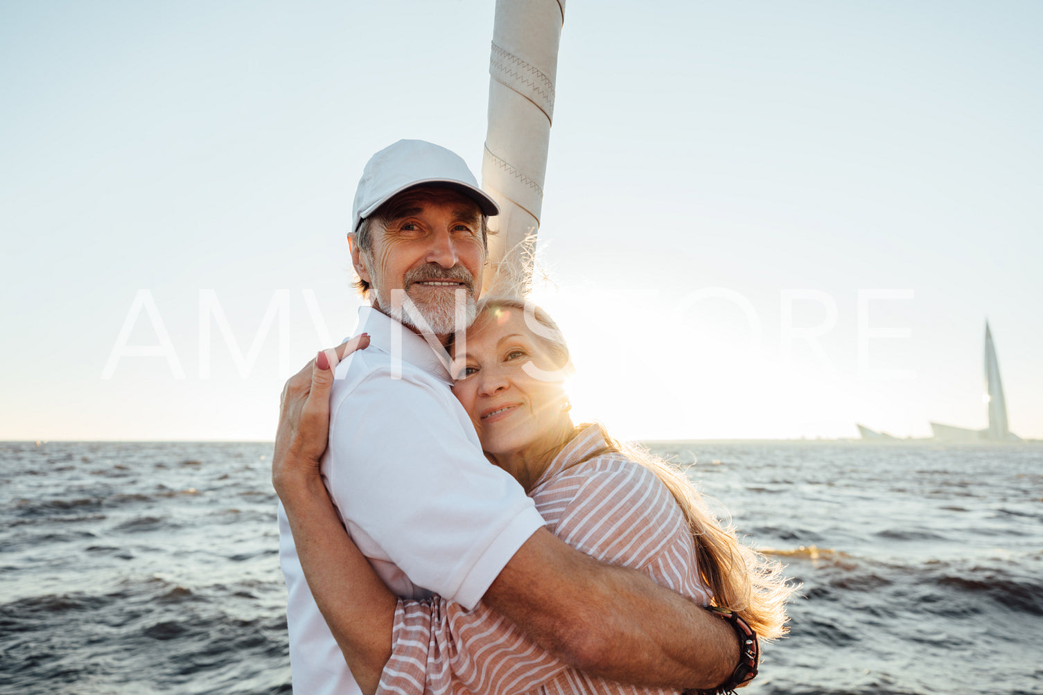 Senior man and woman embracing outdoors. Mature couple enjoying sunset.	