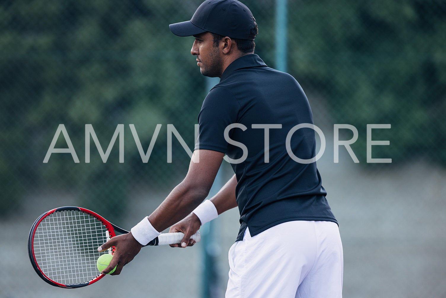 Side view of a tennis player preparing to hit the serve during a match outdoors