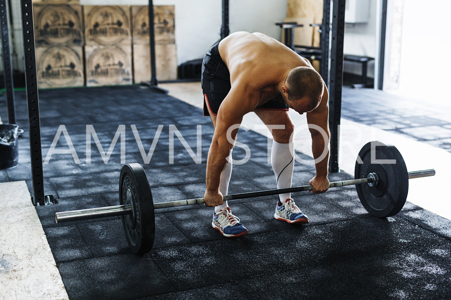 Young athlete preparing for deadlifting in gym	