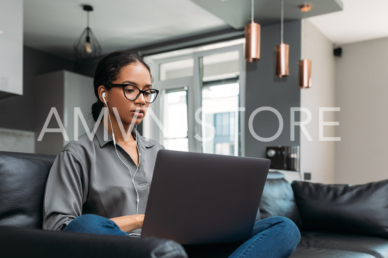 Young female in eyeglasses working from home