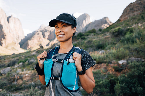 Portrait of a smiling woman in hiking attire looking away while