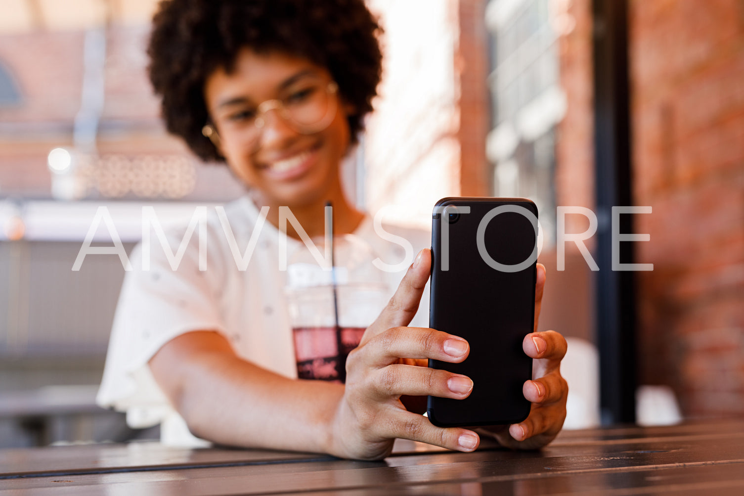 Unrecognizable smiling woman holding a mobile phone and taking selfie	