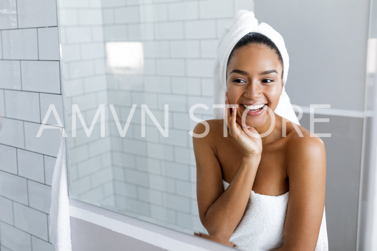 Shot of a beautiful young woman with a towel wrapped around her hair	