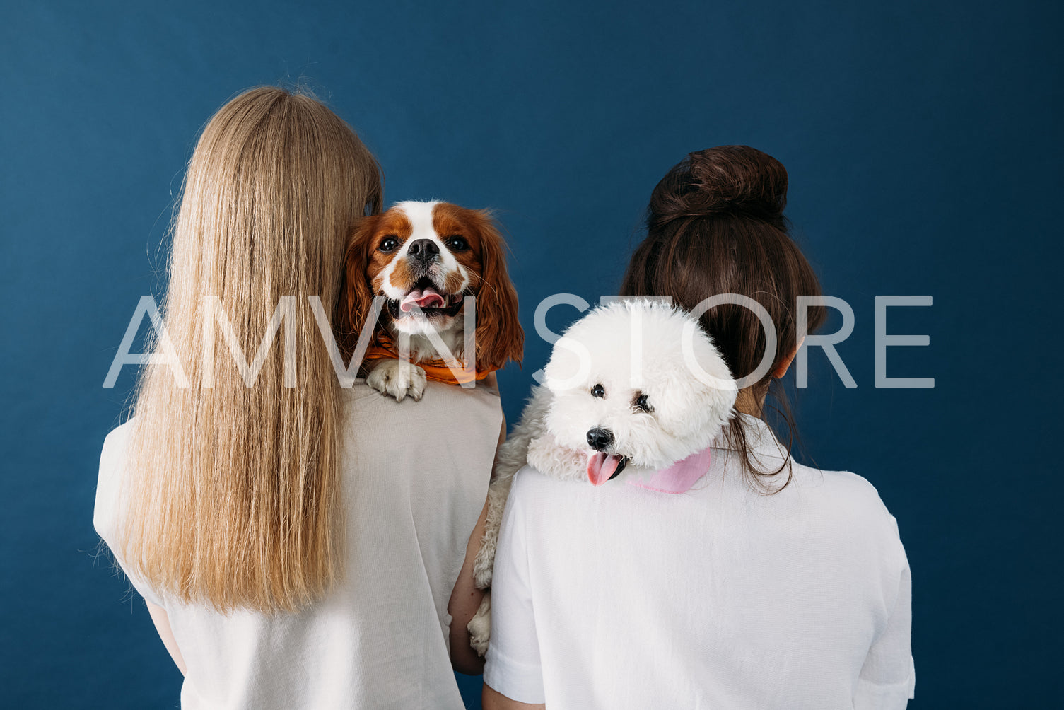 Back view of two women standing with their dogs. Portrait of two