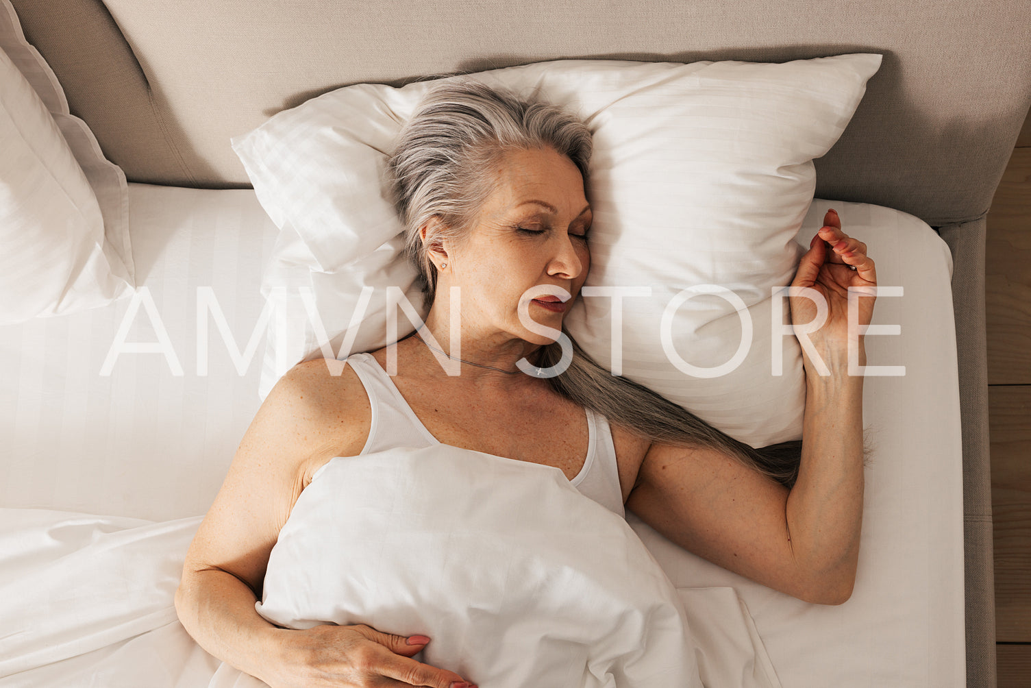 High angle of a senior woman sleeping in her bed