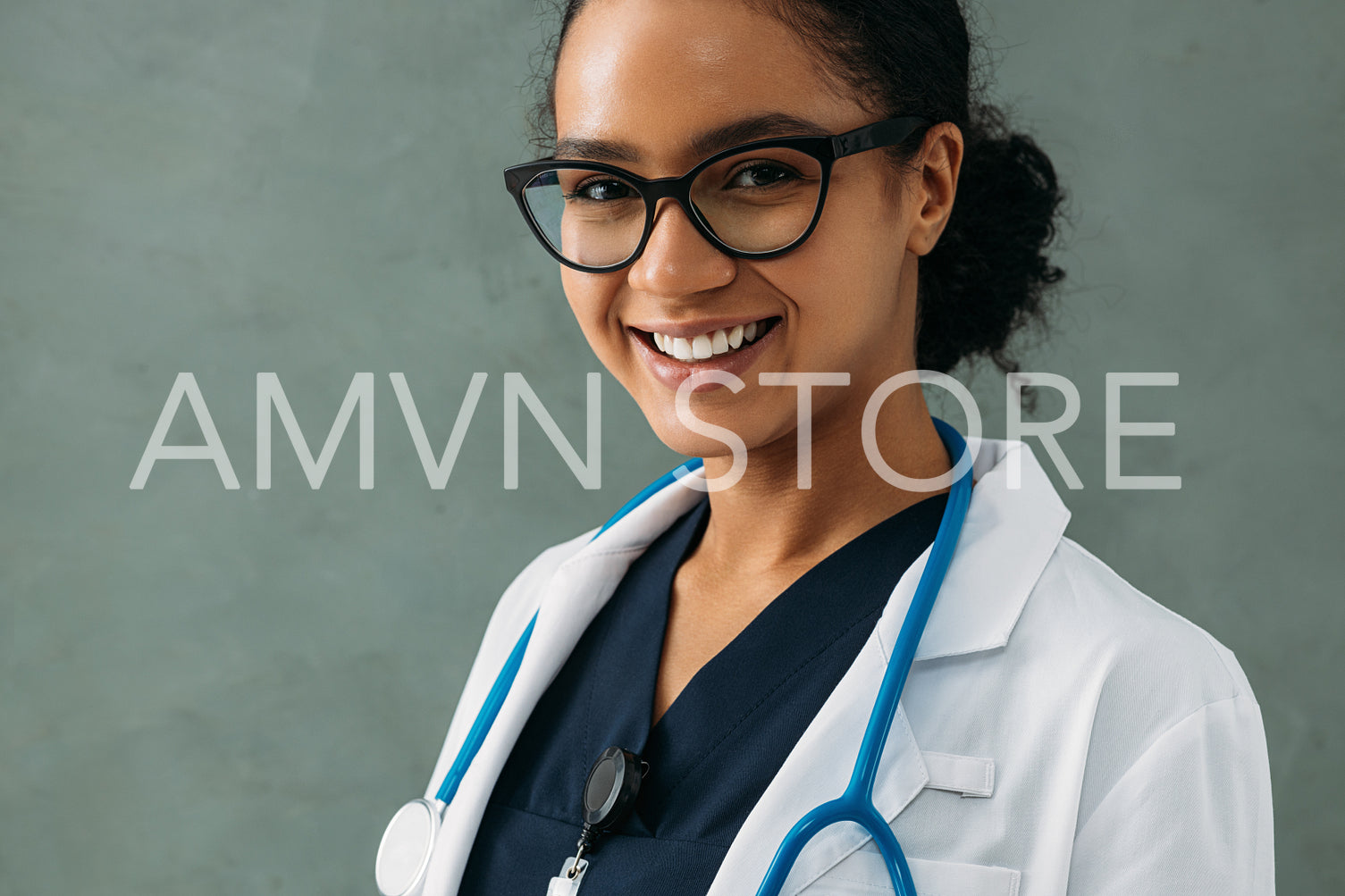 Portrait of a happy beautiful doctor with a stethoscope at a wall	