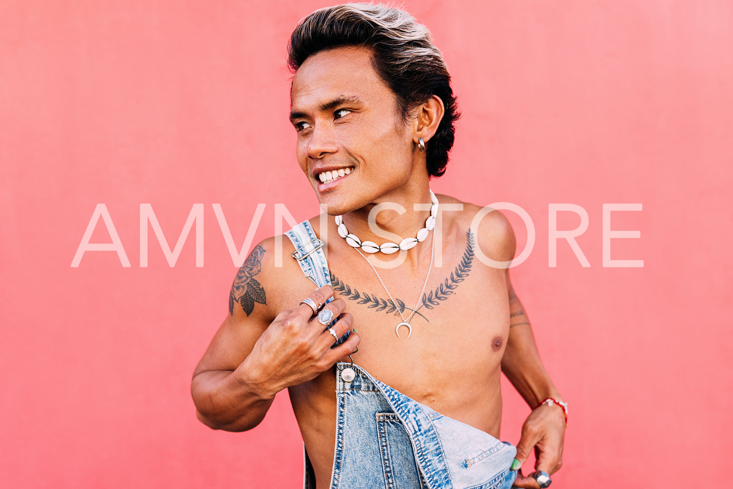 Young smiling man in denim overalls looking away outdoors