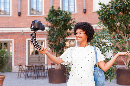 Happy woman shooting video content for her blog