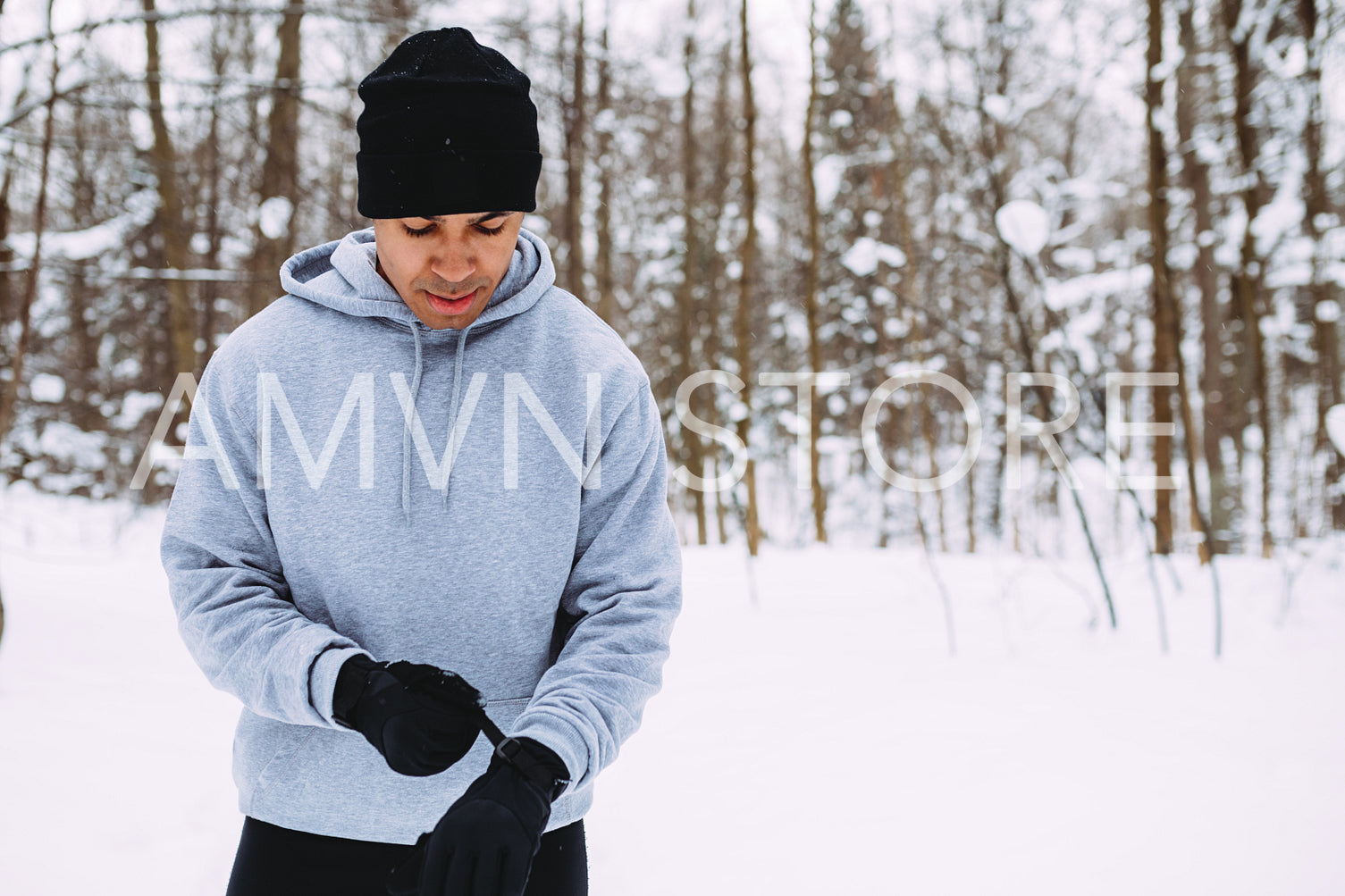 Healthy young male preparing his gloves before training outdoors	
