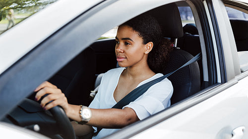 Young woman driving a car. Beautiful businesswoman holding the steering wheel.