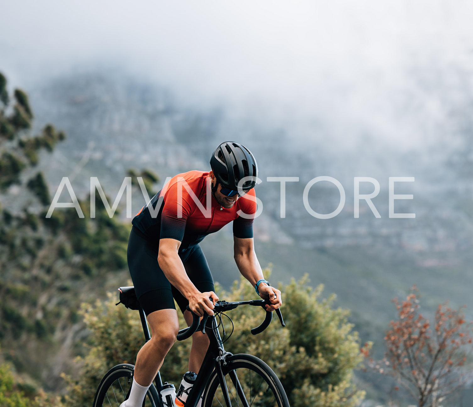 Cyclist on road bike riding in wild terrain. Athlete going up on hill on bicycle.