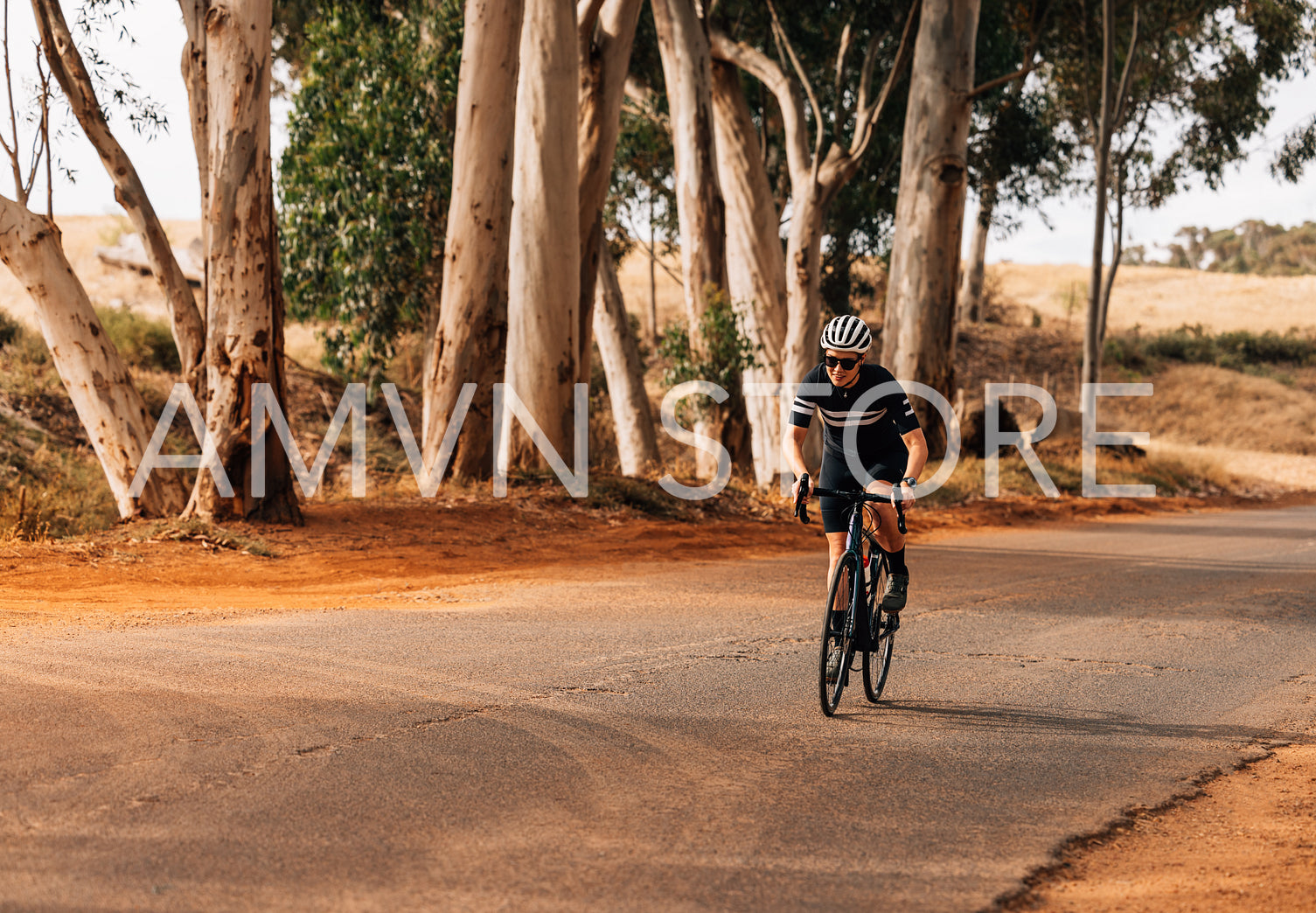 Female athlete riding a pro bike on countryside road