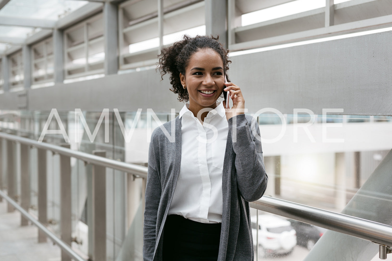 Happy businesswoman talking on cellphone from airport	