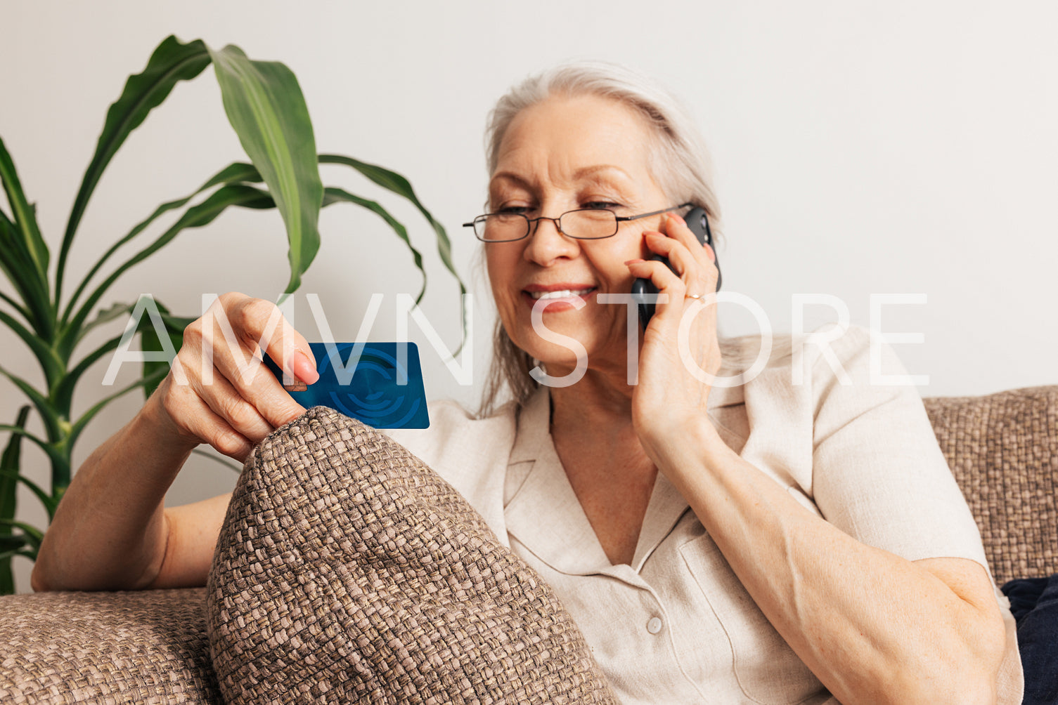 Aged woman holds a credit card